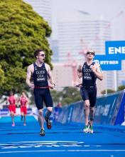  Kyle Coon running to the finish line along with his guide. 